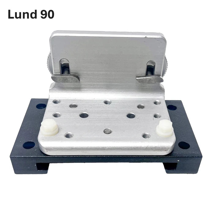 A metal mounting bracket assembly with a brushed silver aluminum plate, a black base plate, and small white plastic feet, shown on a plain white background with the text 'Lund 90' in the top left. Beatdown Sport Track Breakaway Transducer Pole