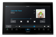 A Garmin touchscreen display device, likely an automotive infotainment or navigation screen, shown on a clean white background. The screen is active, displaying the Spotify app interface with the song 'Catch Me There' by Green Houses, alongside a Spotify and Fusion logos.